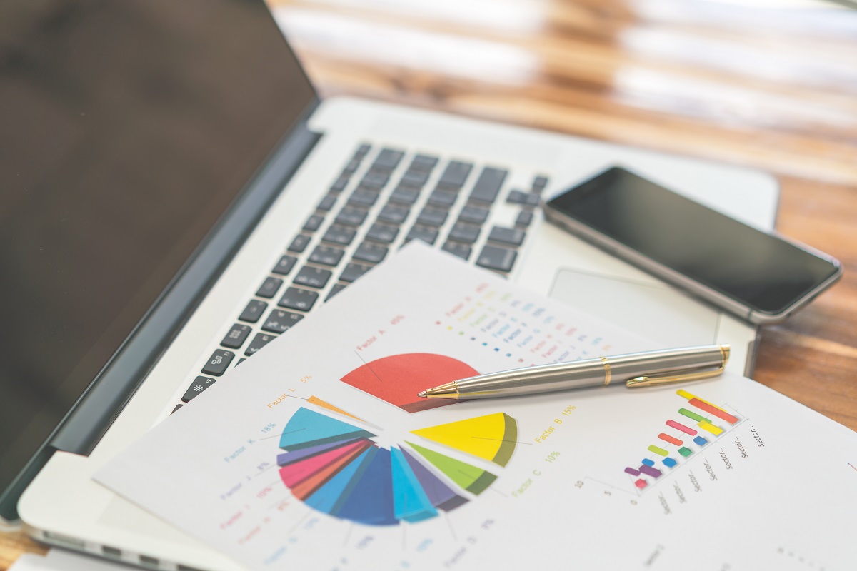 Financial charts on the table with laptop